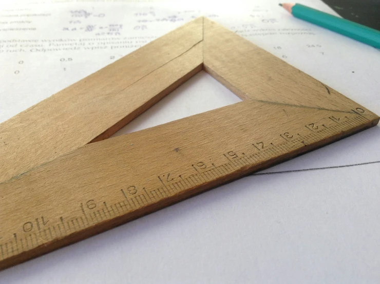 a ruler sits next to a pencil and a pair of scissors