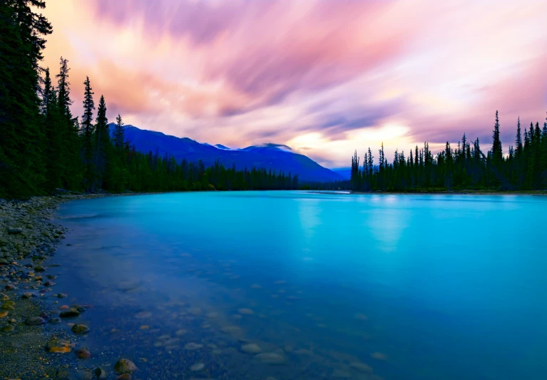 clouds in the sky above the water at night