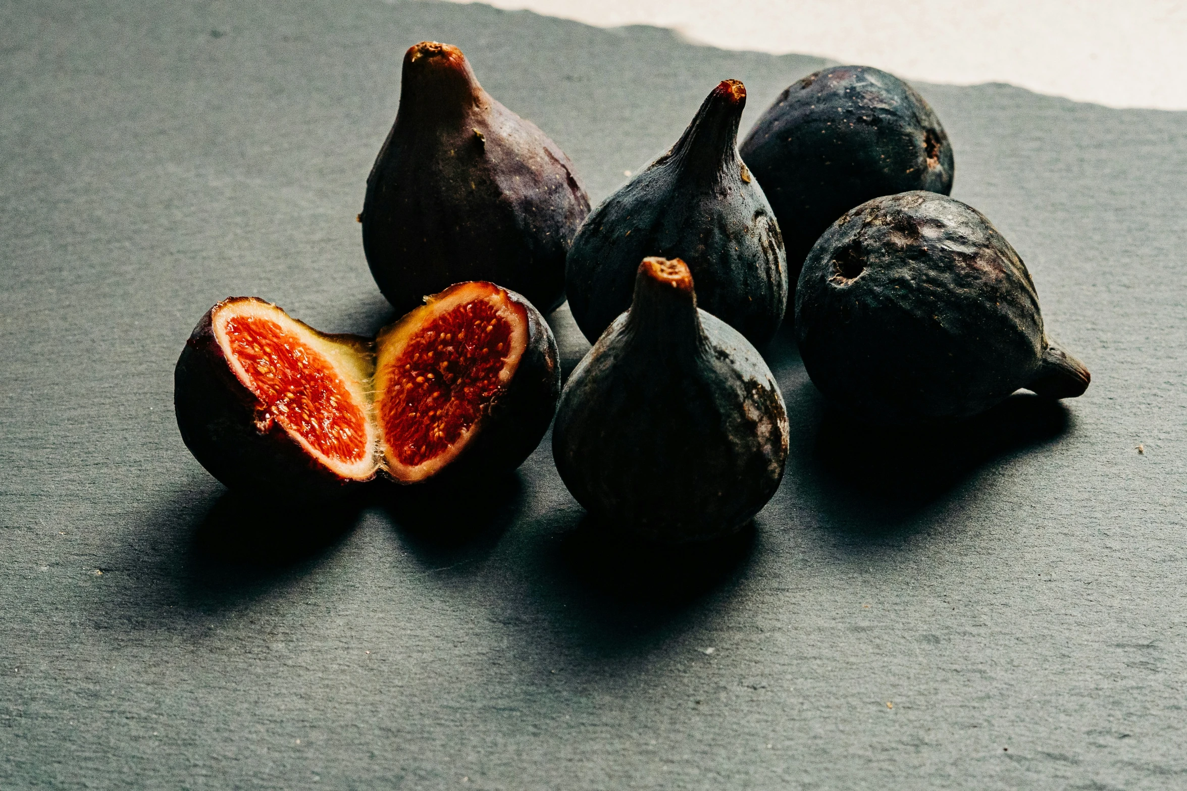 figs on a table with their halves split off