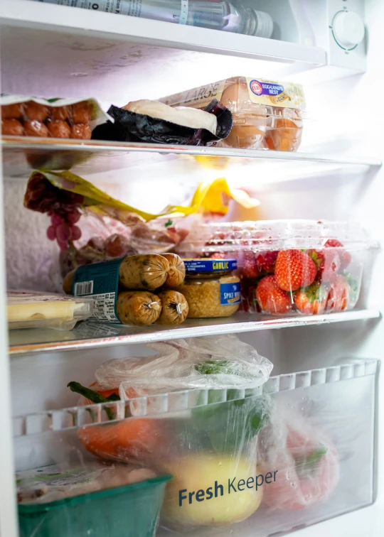 two shelves filled with food inside a fridge