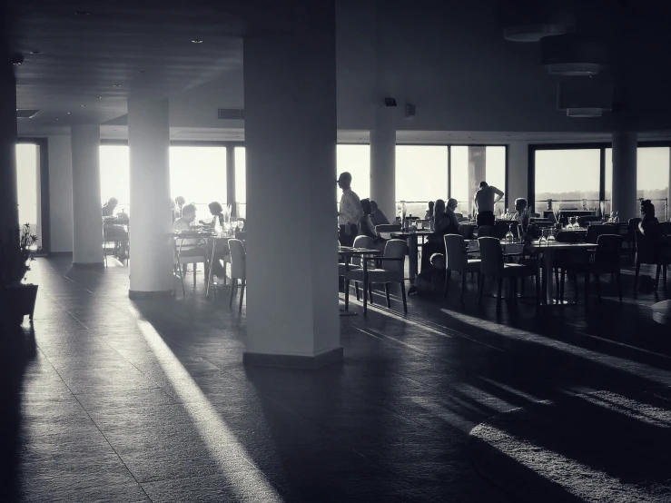 a dining area at a high rise building with many people seated