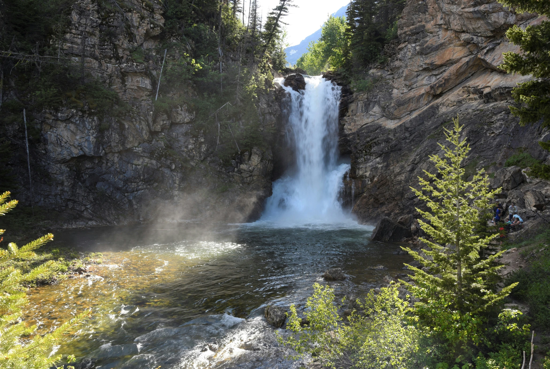 a view of a waterfall from the ground and water coming out