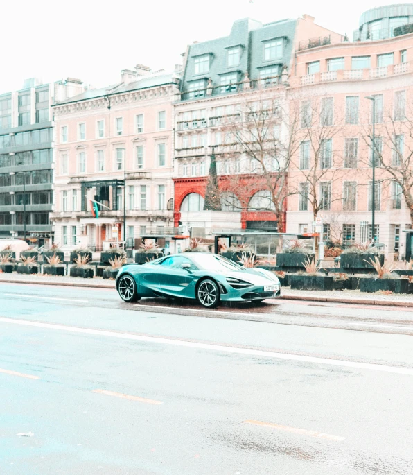 a sports car is parked next to a city street