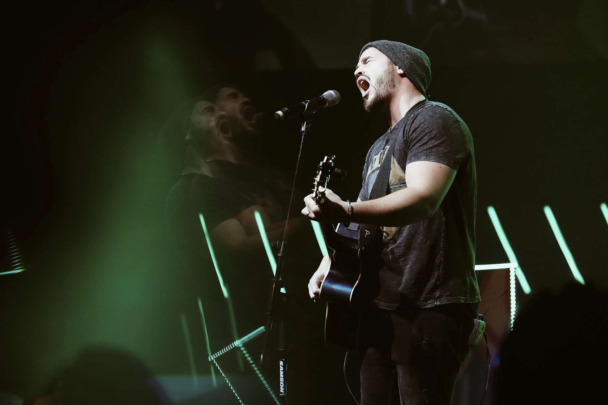 the band's singer at the microphone and singing