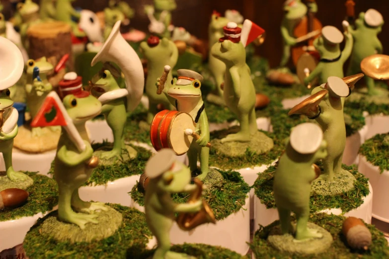 an assortment of clay frogs are on display