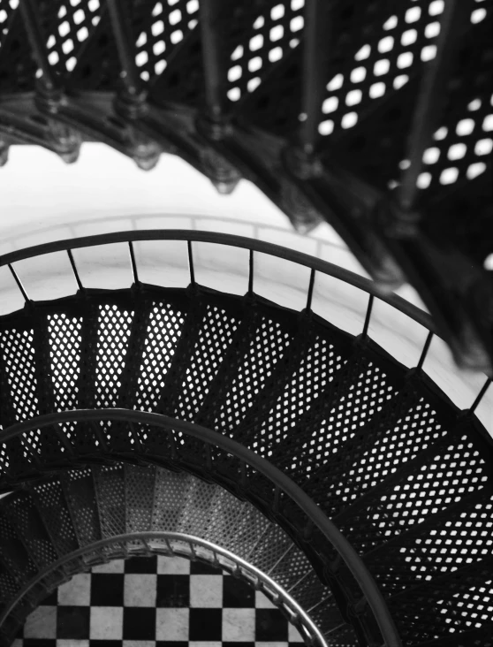 a black and white pograph of the top of a metal spiral staircase