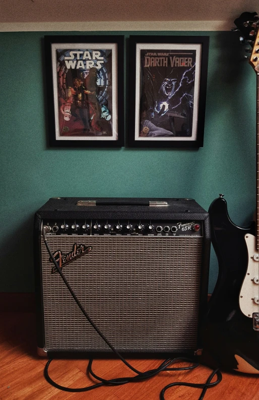 guitar and amp with star wars posters on a wall