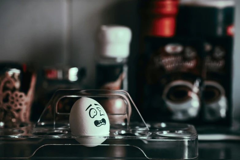 an egg that is next to a beverage bottle