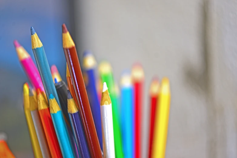 several different colored pencils sticking out of one another