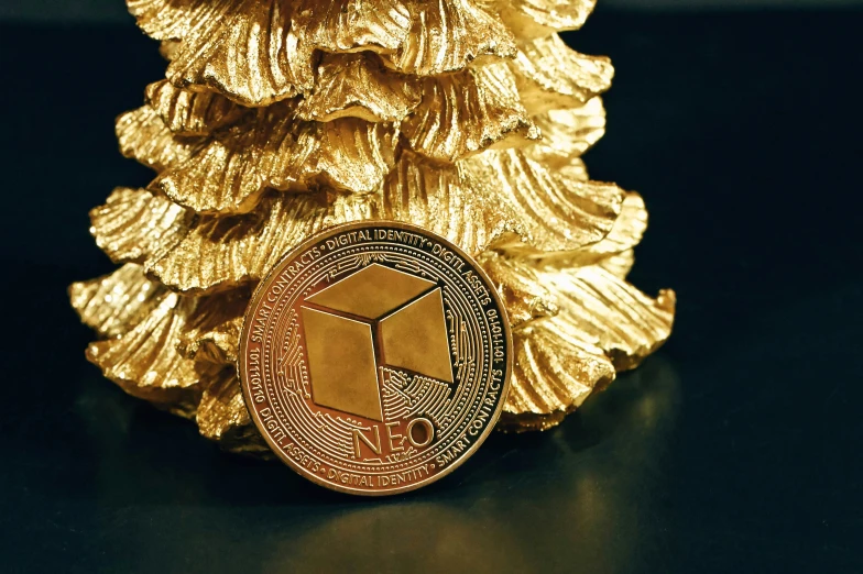 a gold colored pine cone on a black background