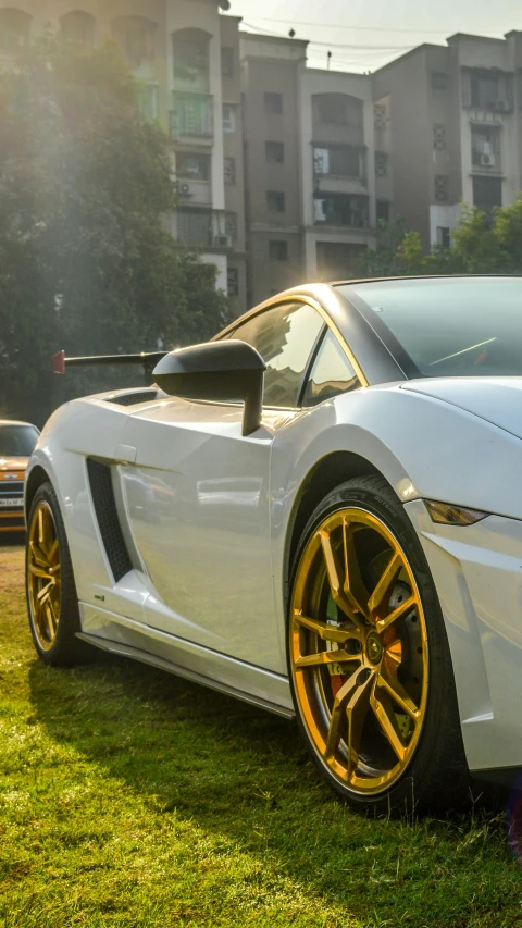 a white car is parked in the grass