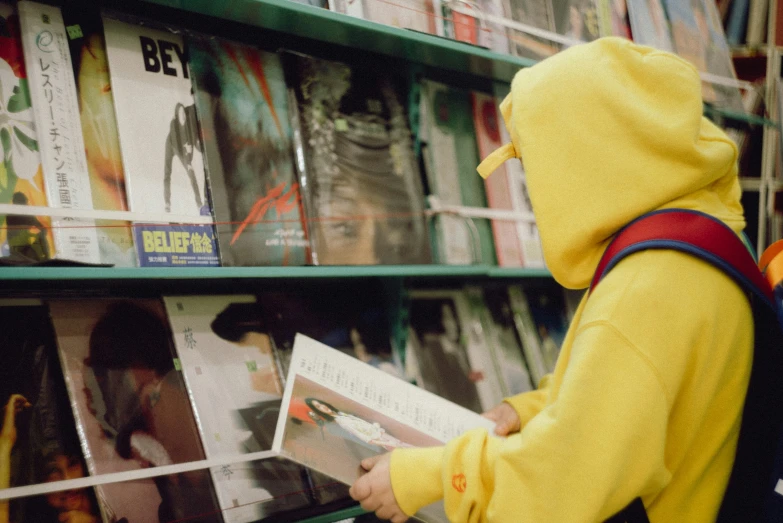 a child looking at comics on a bookcase