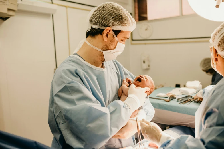 two doctors performing a medical procedure on a baby