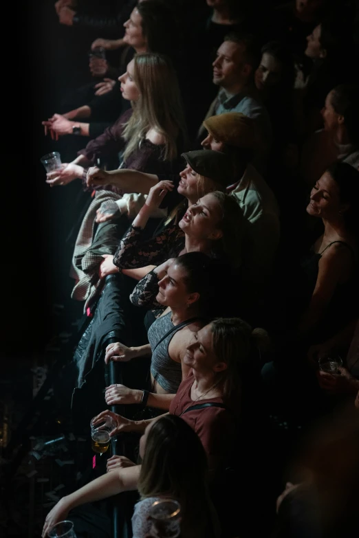 a crowd of people that are sitting in the dark