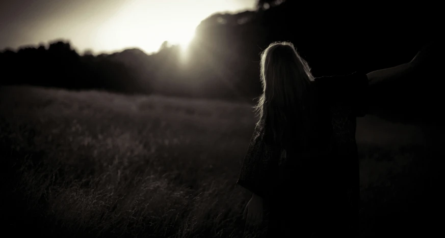 a woman standing in a field on top of a field