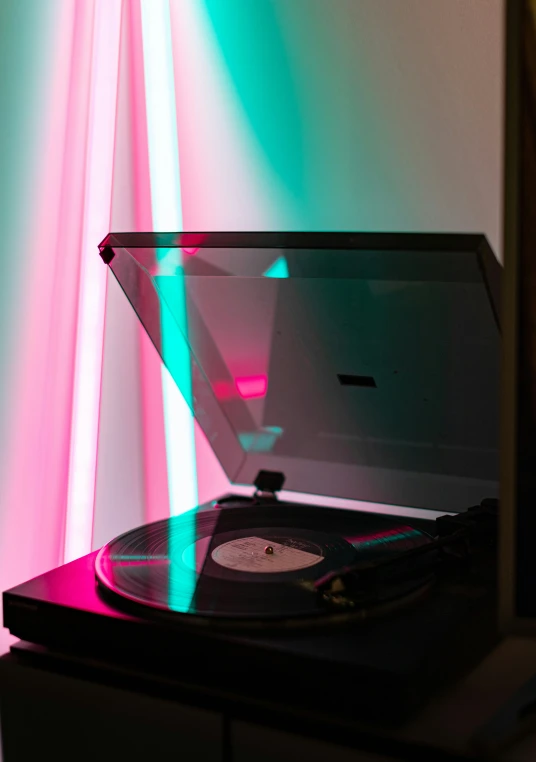 a record player sitting on top of a cabinet