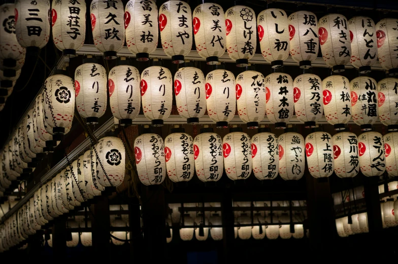 lit up lanterns with characters on them in asian language