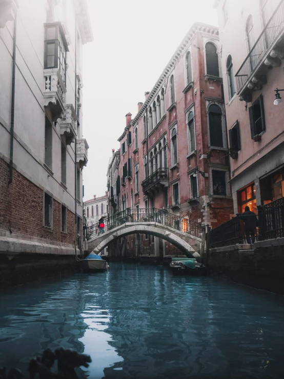 a canal in a small city surrounded by tall buildings