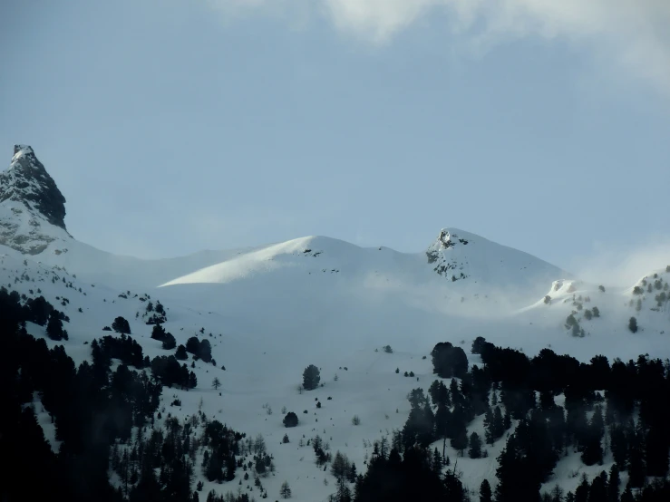 the view from below of a ski lodge looking at a mountain side