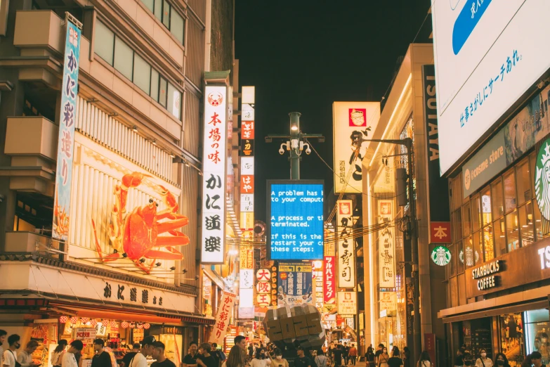 a group of people walk down a busy street