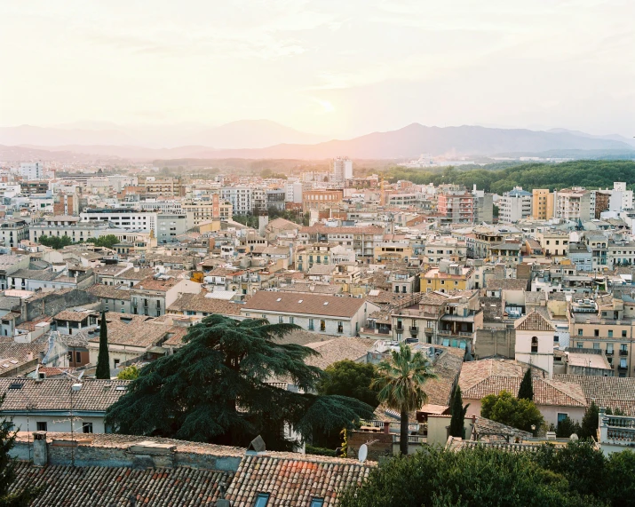 an old city is full of houses, with mountains in the background