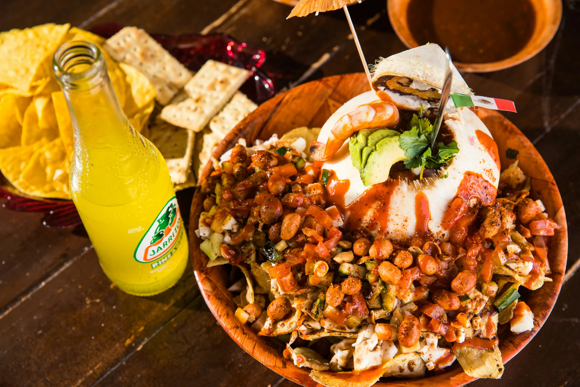 a plate of food with corn chips and a drink