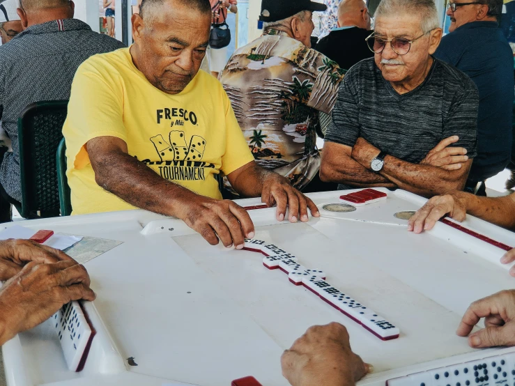 a group of men sit around a table to work