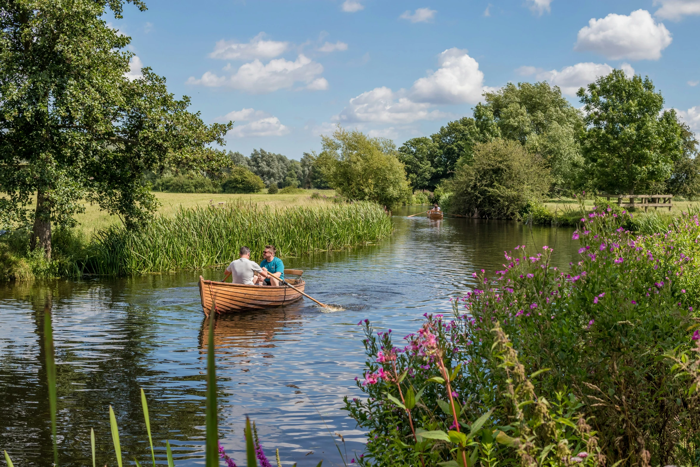 a small boat with people inside floating on water