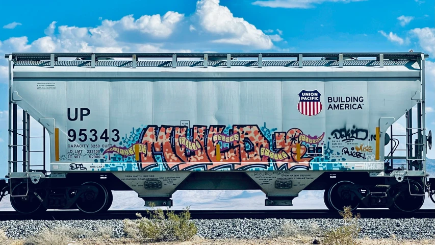 a white box car with some graffiti on it
