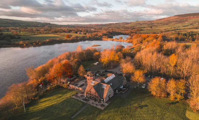 an aerial view of an over head, leafless country house and surrounding lake