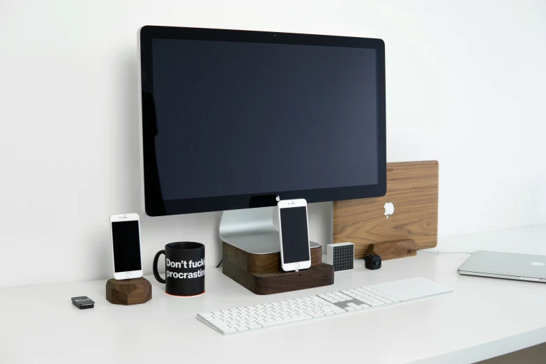 a laptop and desktop computer sit side by side