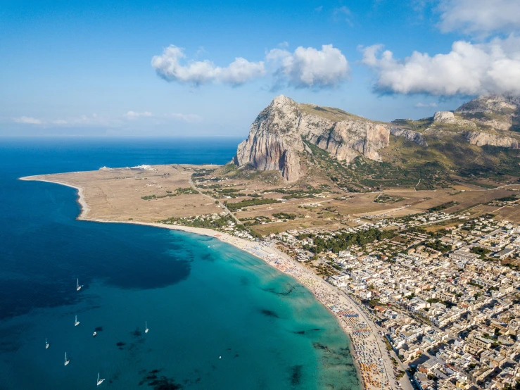 aerial view of town on the edge of mountains and beach