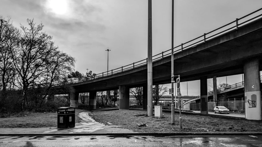 a street view looking down the road in front of a bridge