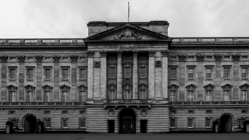 black and white image of building with clocks on top