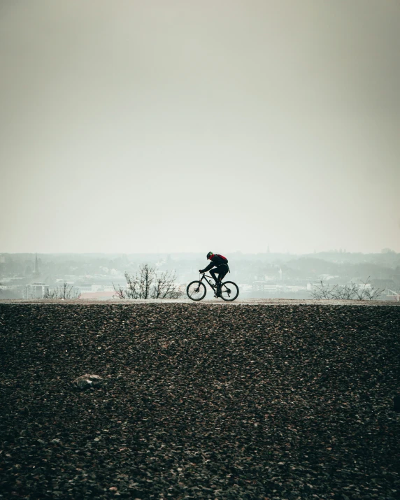 a person is riding his bicycle near a field