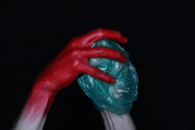 a close up view of hands with red paint