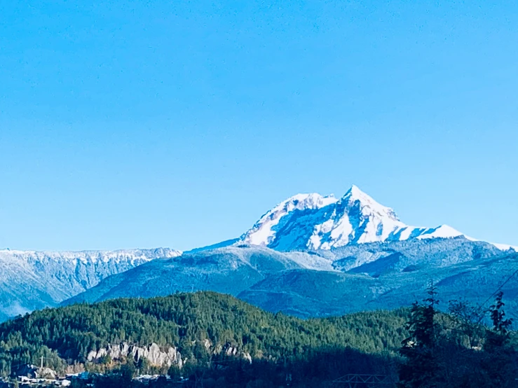 the mountains are dotted with snow on them