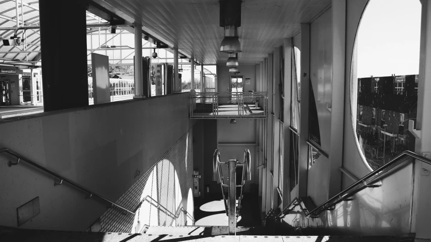 a hallway leading to some stairs and some windows