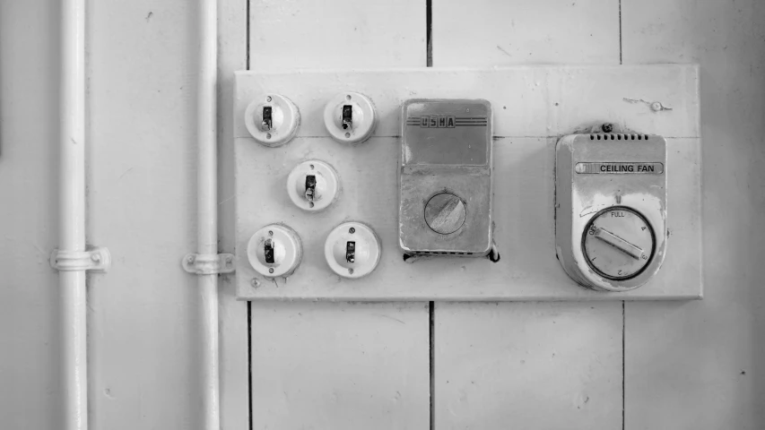 a wall with various types of bathroom controls