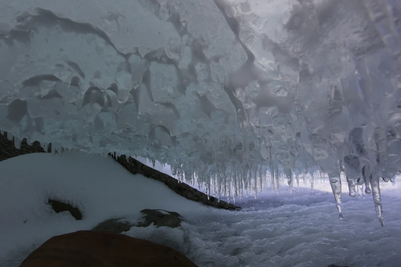 icicles hanging off the side of a mountain in winter