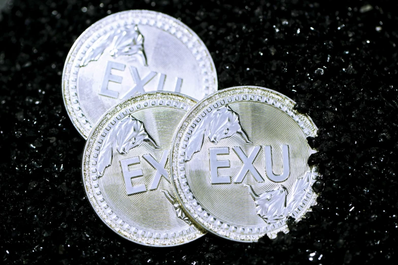 two piles of israeli five - euro coins sitting on top of a black counter