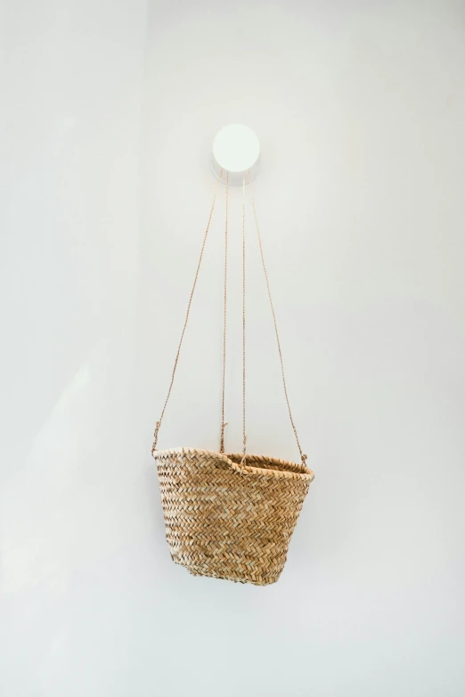 a basket hanging from an object on the wall