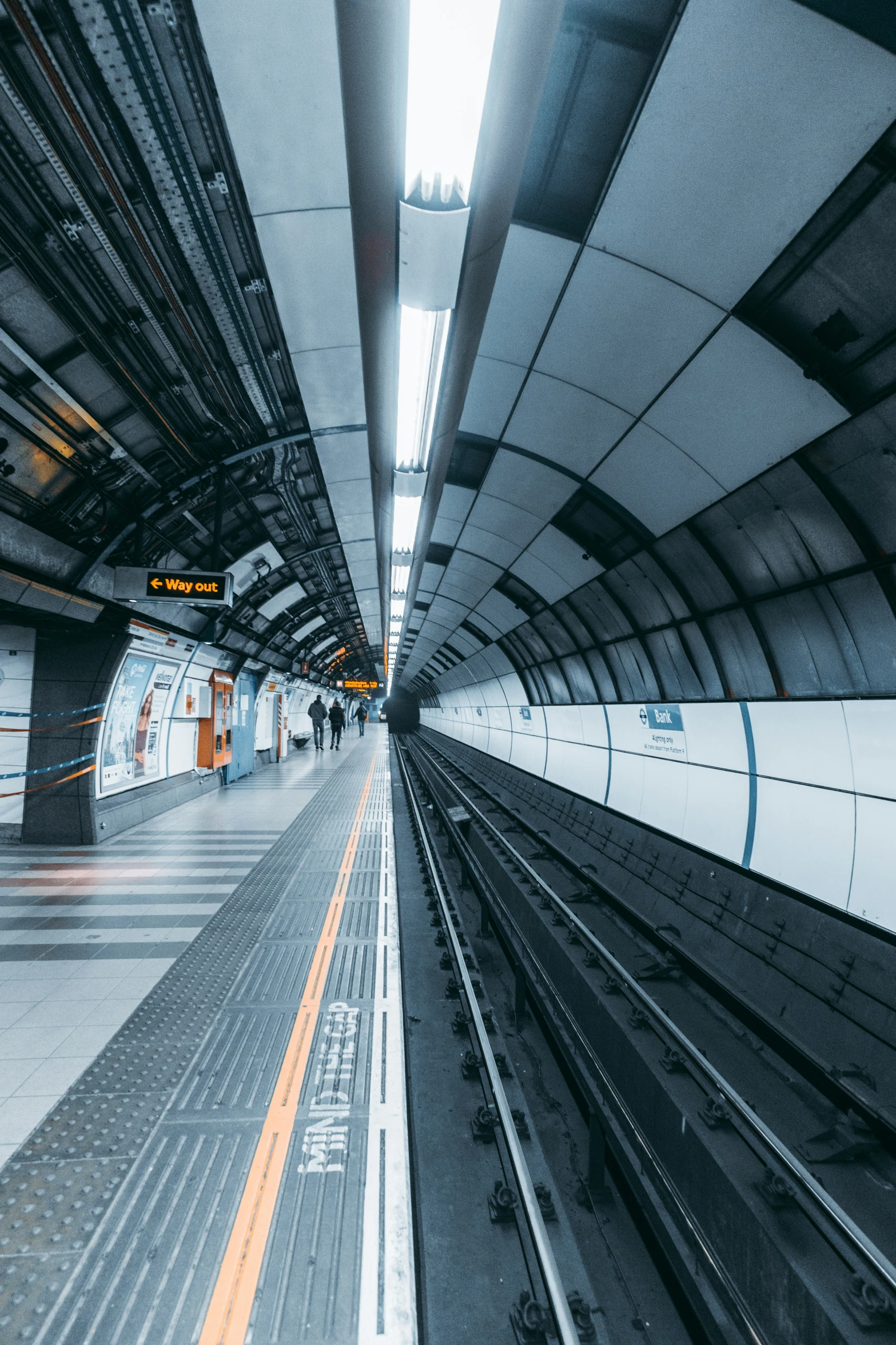 a long train track in a subway station