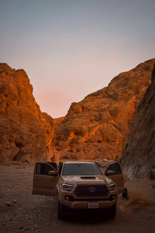 two trucks parked at sunset in between mountain ranges