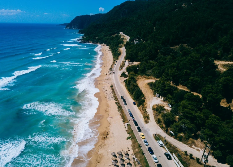 an aerial s of the beach with cars parked