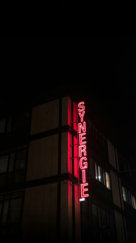 a building at night with a large neon sign