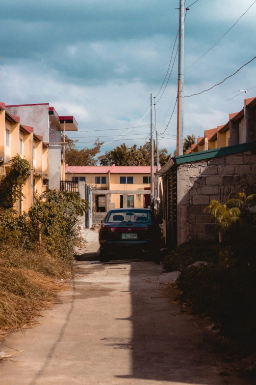 a car is parked on a narrow street