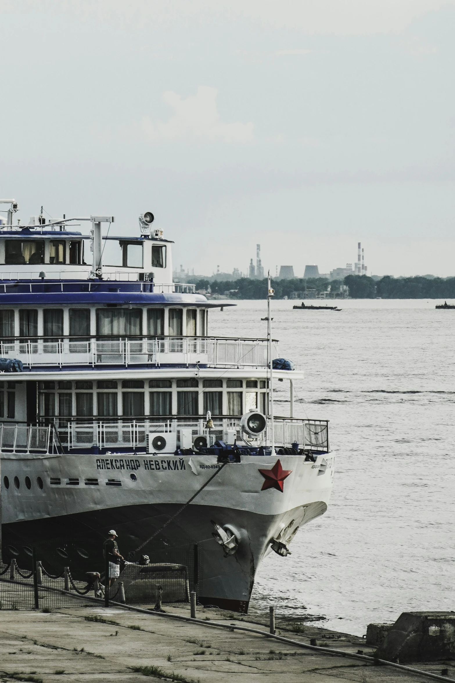 a white cruise ship is docked in a harbor