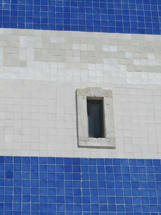 a large window in a brick building near tiles