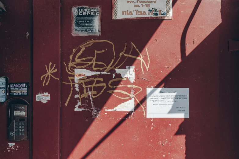 a red door with some graffiti on it